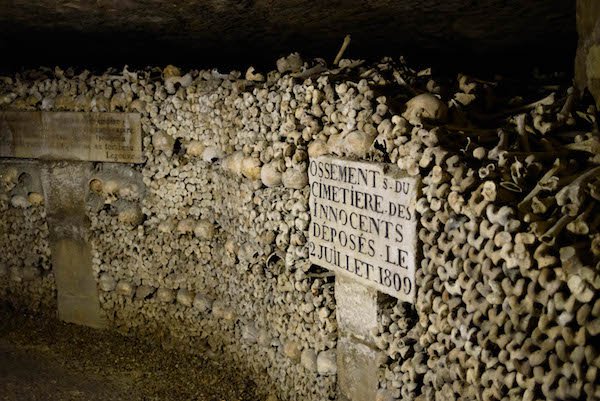 Paris Catacombs, France.
Since the 13th century, the ground beneath Paris has been mined for limestone and other minerals, so the entire ground that the city sits on is a labyrinth of tunnels. A little over half of those tunnels are mapped, while the rest are left to speculation. Back in 1800’s, the graveyards of Paris were getting so full, that they had to start transferring the bones to the tunnels, and arranged them in a Gothic display. This ossuary (where the bones are kept) are open to the public for you to check out and even touch, if you wanted to. If that’s your thing. We won’t judge.
