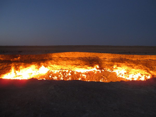 Door to Hell, Derweze, Turkmenistan.
The entire area of Derweze is rich in natural gas. While drilling in 1971, soviet geologists tapped into a cavern filled with natural gas, and caused the cavern to collapse, creating a huge hole with a diameter of 229 feet. To avoid the gas discharging and poisoning the air, they decided to burn it off. They figured it would burn out in a matter of days, but it’s been 46 years.
It literally looks like the doorway to the hottest place in the afterlife. That’s a hell nope!
