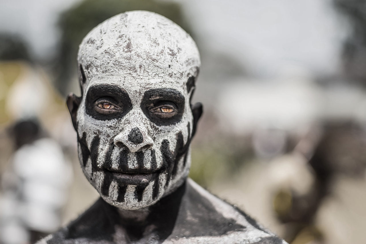 A tribesman from rural Papua New Guinea with his face painted like an undead spirit