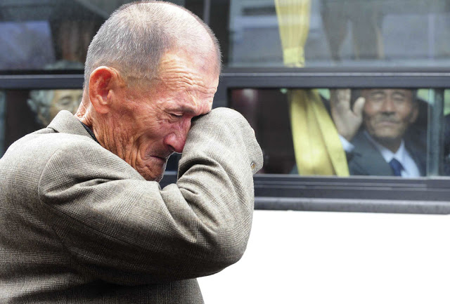 North Korean waves at his South Korean brother after inter-Korean temporary family reunions in 2010