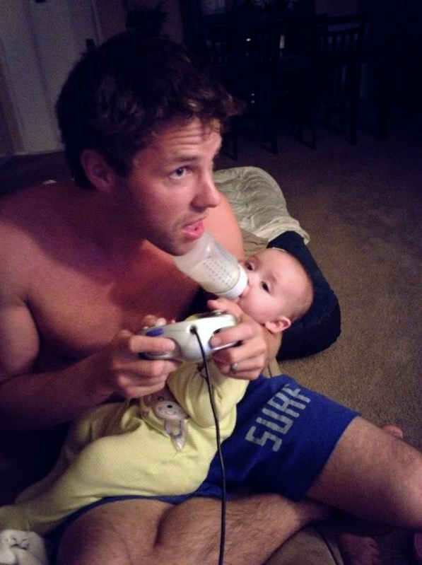 father playing video games with baby