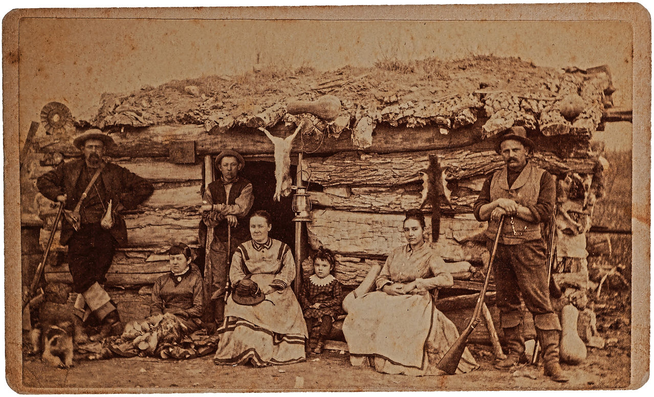 Kansas homesteaders, family of seven, in front of their log cabin. 1878
