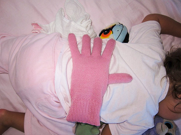 When you're feeling tired but want your kid to feel loved, put a bean filled glove on your baby's back.
