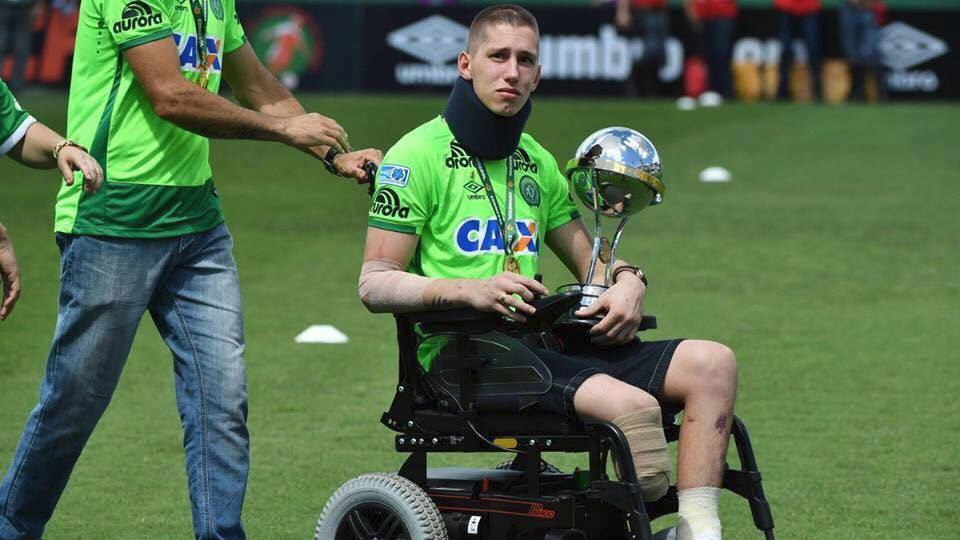 Chapecoense plane tragedy survivor Jakson Follmann returns to his home stadium for the first time since the crash holding the Copa Sudamerica Trophy