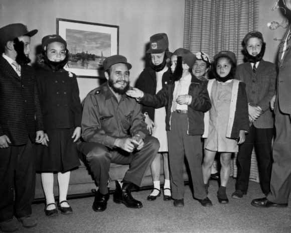 Fidel Castro with children all wearing fake beards to poke fun at the dictator, 1969
