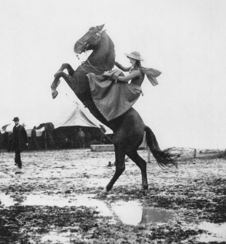 Annie Oakley, famous for her shooting skills, shows off her riding skills in 1890