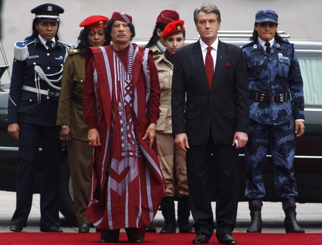 Former Libyan leader Muammar Gaddafi (left) with his all female bodyguards walking with former Ukrainian President Viktor Yushchenko in Kiev in 2008.