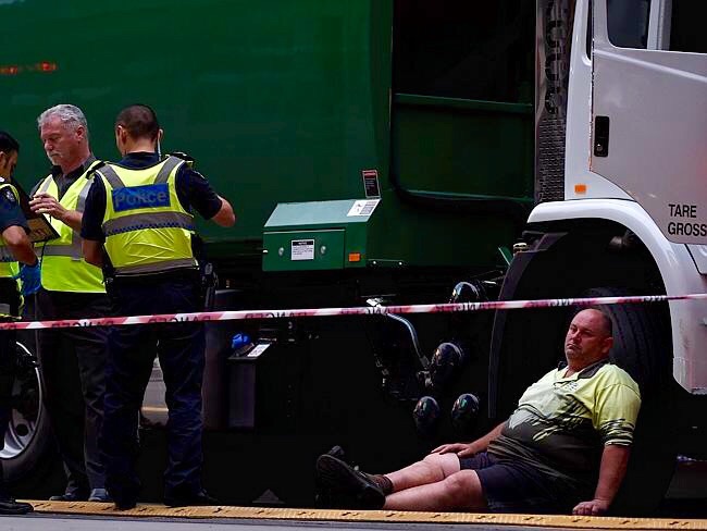 A garbage truck driver’s thousand yard stare after accidentally running over and killing a young woman who tripped and fell on a pedestrian crossing