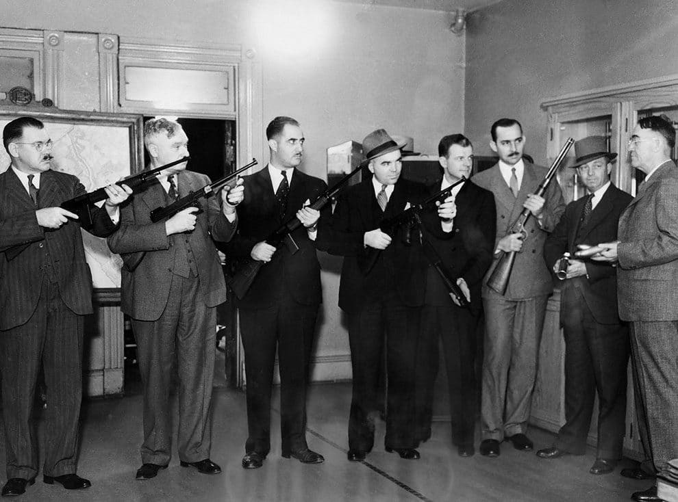 Photo shows Inspector Frank S. Burke, Right, Chief of Detectives, explaining the new weapons to some of his men, left to right, Detectives O. S. Hunt, Thomas Nally, John Apostolides, Robert Barret, Joseph Shinon, Hoyle Secrest, George Darnell and Inspector Burke in Washington, DC on October 19, 1935