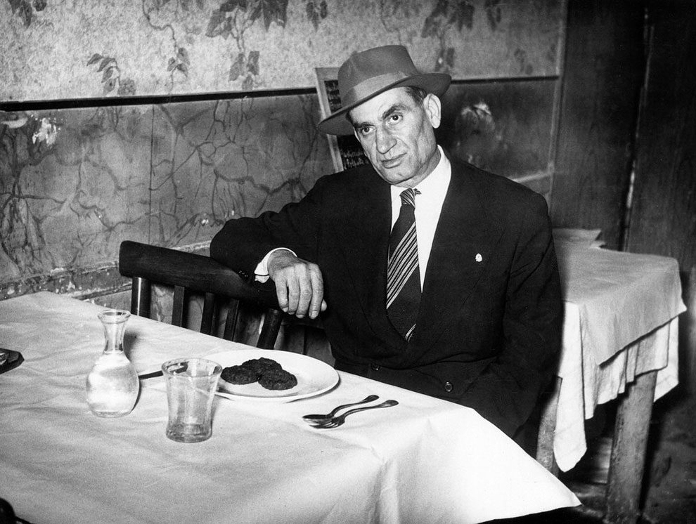 Italian-American mafioso Frank Frigenti sitting at a table in a restaurant. Italy, 1950s