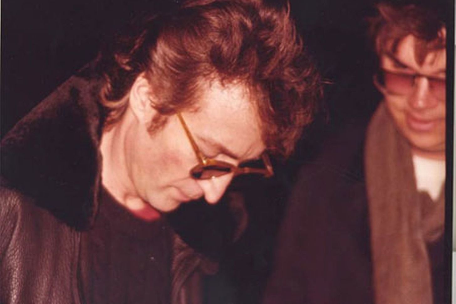 John Lennon.
An ironic last photo of John Lennon signing an autograph for the man who turned out to be his killer (man on the right of the photo). Lennon was fatally shot on December 8, 1980, Manhattan, New York.