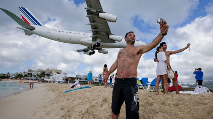 beach with plane flying over