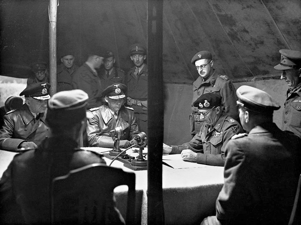 Field Marshal Bernard Montgomery signs the surrender of German forces in the Netherlands, in northwest Germany and Denmark – 4th May 1945.

After lunch, Field Marshal Montgomery called the Germans back for further consultation, and there he delivered his ultimatum … He told the Germans: “You must understand three things: Firstly, you must surrender to me unconditionally all the German forces in Holland, Friesen and the Frisian Islands and Helgoland and all other islands in Schleswig-Holstein and in Denmark. Secondly, when you have done that, I am prepared to discuss with you the implications of your surrender: how we will dispose of those surrendered troops, how we will occupy the surrendered territory, how we will deal with the civilians, and so forth. And my third point: If you do not agree to Point 1, the surrender, then I will go on with the war and I will be delighted to do so.” Monty added, as an after-thought, “All your soldiers and civilians may be killed.”