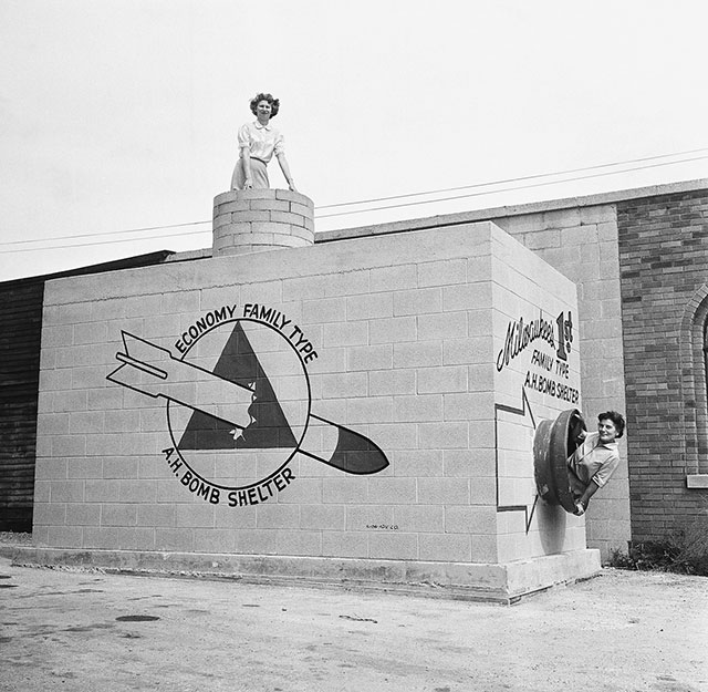 Economy Family Type A-Bomb Shelter.

Beverly Wysocki, top, and Marie Graskamp, at side, emerge from a new family-type bomb shelter on display in Milwaukee, Wis., Sept. 12, 1958. The shelter can hold 8 to 12 persons and would be safe to within three quarters of a mile of ground zero if a 20 megaton nuclear bomb were to be dropped.