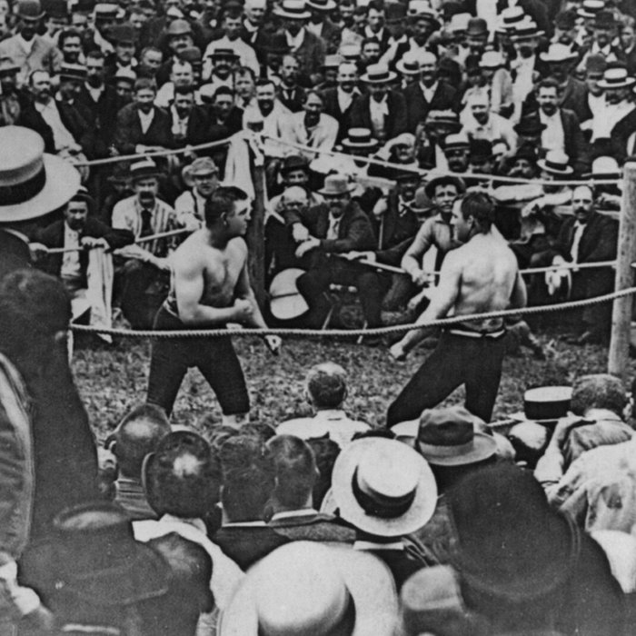 The last bare-knuckle heavyweight championship fight at Richburg, Mississippi, in which John L. Sullivan (left) defeated Jake Kilrain in 75 rounds. It was one of the first American sporting events to receive national press coverage. 1889