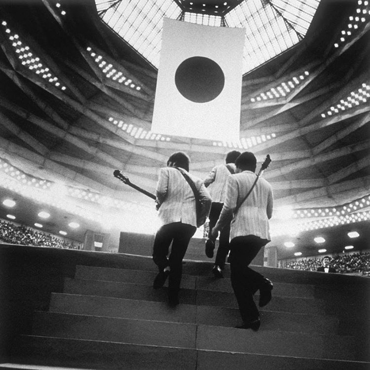The Beatles step onstage in Tokyo, Japan. 1966
