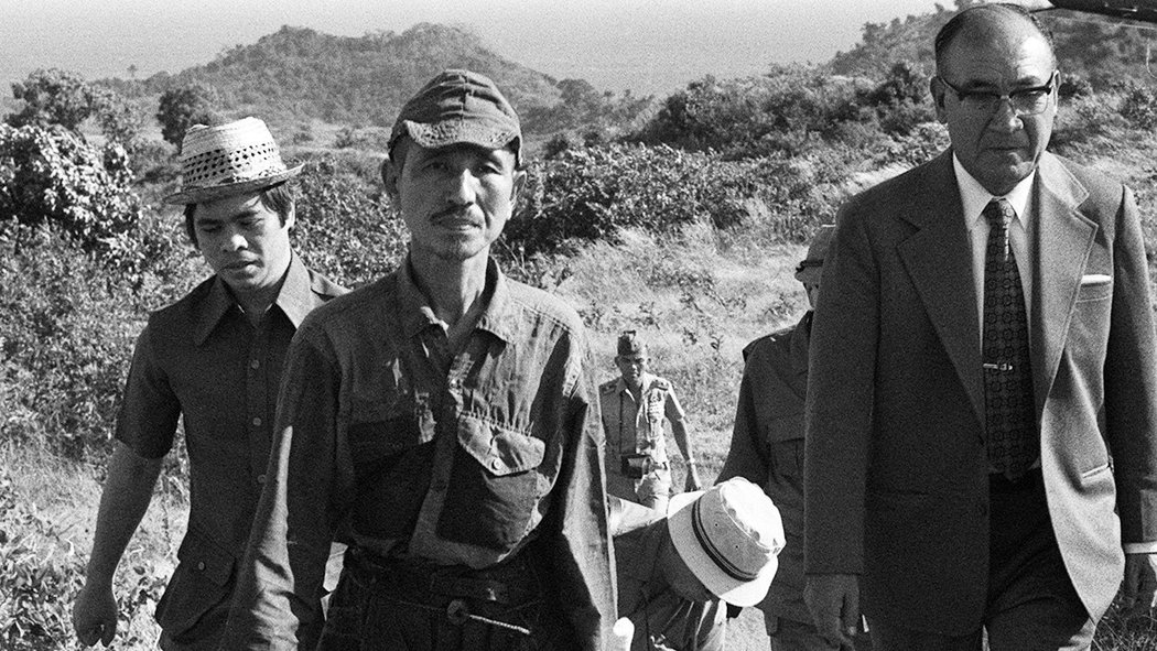 A Japanese soldier in WWII, Hiroo Onoda, held out for 29 years, and refused to quit fighting until he was convinced the war was over… in 1974.

On December 26th, 1944, Onoda was sent to Lubang Island in the Philippines.  His orders from his commanding officers, Major Yoshimi Taniguchi, were simple:
You are absolutely forbidden to die by your own hand. It may take three years, it may take five, but whatever happens, we’ll come back for you. Until then, so long as you have one soldier, you are to continue to lead him. You may have to live on coconuts. If that’s the case, live on coconuts! Under no circumstances are you [to] give up your life voluntarily.
Onoda first saw a leaflet that claimed the war was over in October 1945. When another cell had killed a cow, they found a leaflet left behind by the islanders which read: “The war ended on August 15. Come down from the mountains!”2 But as they sat in the jungle, the leaflet just didn’t seem to make sense, for another cell had just been fired upon a few days ago. If the war were over, why would they still be under attack? No, they decided, the leaflet must be a clever ruse by the Allied propagandists.
Again, the outside world tried to contact the survivors living on the island by dropping leaflets out of a Boeing B-17 near the end of 1945. Printed on these leaflets was the surrender order from General Yamashita of the Fourteenth Area Army.
Having already hidden on the island for a year and with the only proof of the end of the war being this leaflet, Onoda and the others scrutinized every letter and every word on this piece of paper. One sentence in particular seemed suspicious, it said that those who surrendered would receive “hygienic succor” and be “hauled” to Japan. Again, they believed this must be an Allied hoax.
Leaflet after leaflet was dropped. Newspapers were left. Photographs and letters from relatives were dropped. Friends and relatives spoke out over loudspeakers. There was always something suspicious, so they never believed that the war had really ended.