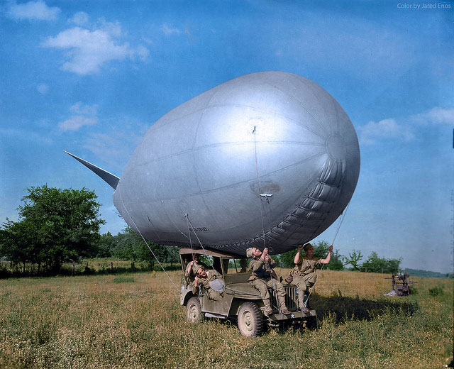 US Army soldiers use a jeep to move a Very Low Altitude (VLA) antiaircraft balloon (barrage balloon) during a training exercise in southern England before D-Day, circa May 1944.