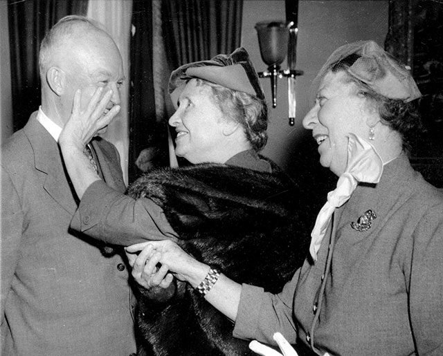 Helen Keller, 73, who is blind and deaf, guides her hand over U.S. President Dwight Eisenhower’s face as her companion Polly Thomson communicates the President’s comments by sign language on Keller’s palm, November 3, 1953