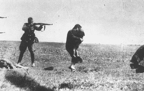 A German soldier executes a Ukrainian Jew embracing her child. Ivanhorod, Ukraine, 1942