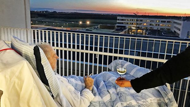 Old man gets hes last wish fulfilled, a cigarette and a glass of wine on the roof of the hospital