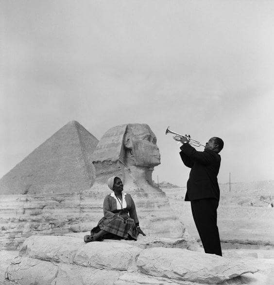 Louis Armstrong plays for his wife in front of the Sphinx by the pyramids in Giza, 1961