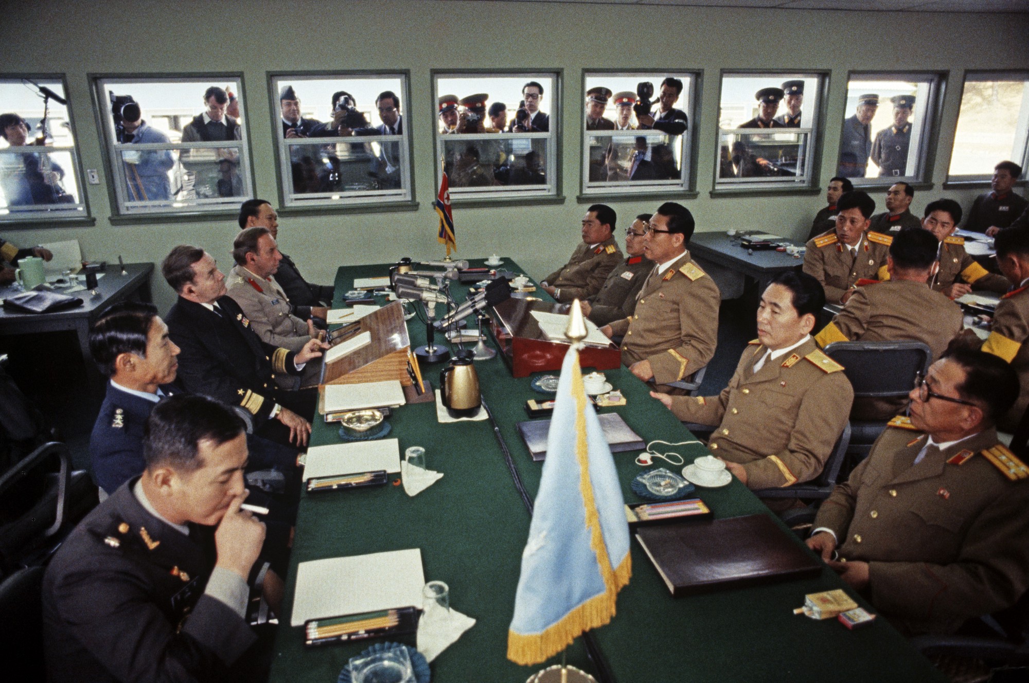 Negotiations between North and South Korea take place at a table — itself bisected by the DMZ line — in Panmunjom in 1983