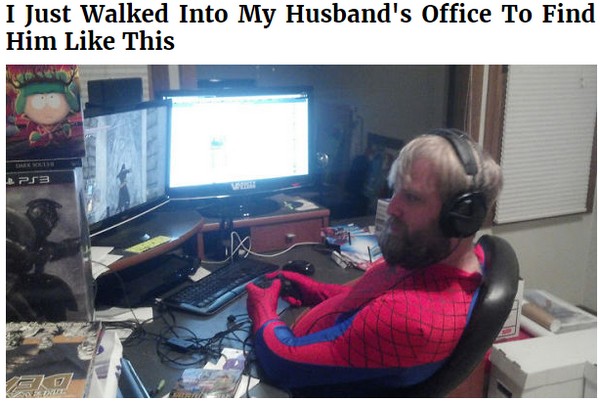 Husband on the computer while wearing a full Spiderman outfit.