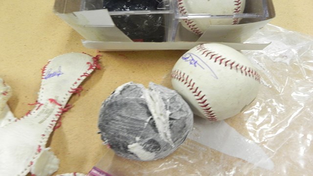 That baseball looks awfully lumpy, probably because it's fake and stuffed with cocaine.