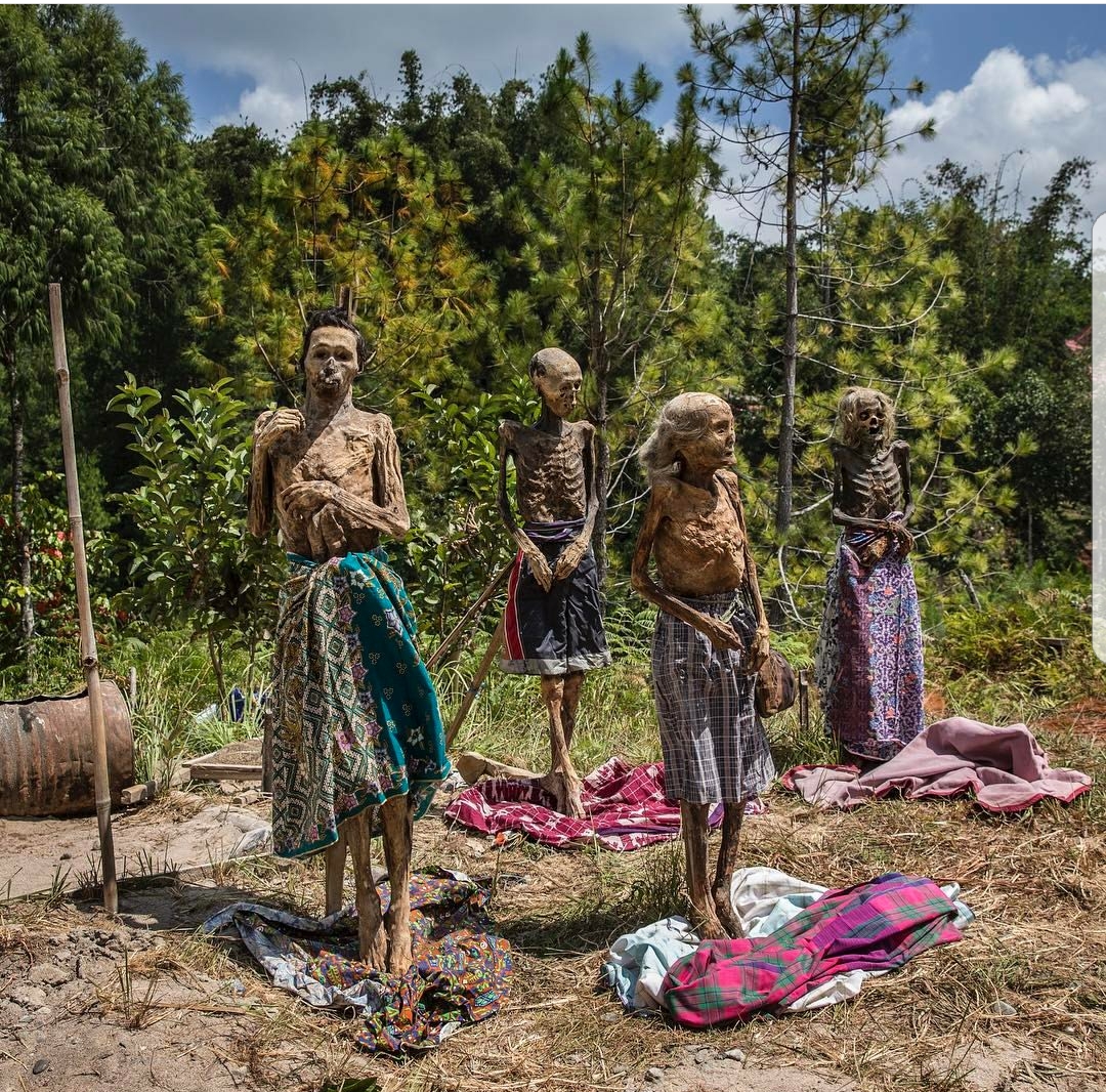 A rare death ritual in Indonesia. Family members gather to remove their relatives from their graves, change their clothes, dust them off, and let them dry in the sun
