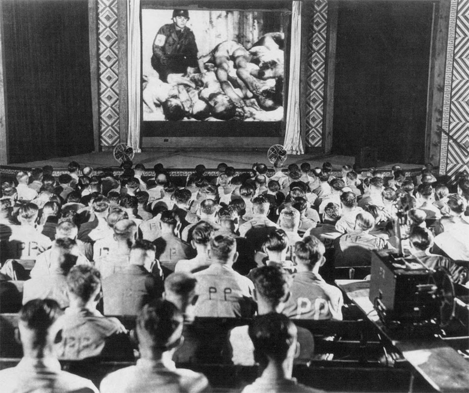 German POWs forced to watch footage of concentration camps 1945.

This forced process was part of the Allied policy of postwar denazification, meant to purge Germany of the remnants of Nazi rule and rebuild its civil society, infrastructure, and economy. The program included compulsory visits to nearby concentration camps, posters displaying dead bodies of prisoners hung in public places, and forcing German prisoners of war to view films documenting the Nazis’ treatment of “inferior” people.
The footage came from a newsreel shown in the US that was seen by millions and millions of people at the time. Seeing is believing. Often the only thing capable of denting humanity’s monumental ability to bunker down in a state of denial is indisputable, visual evidence. When cruel things take place on a massive and institutionalized scale behind closed doors and out of sight in societies, only jarring confrontation can shatter the delusions. If the ear won’t listen, tell it to the eye.