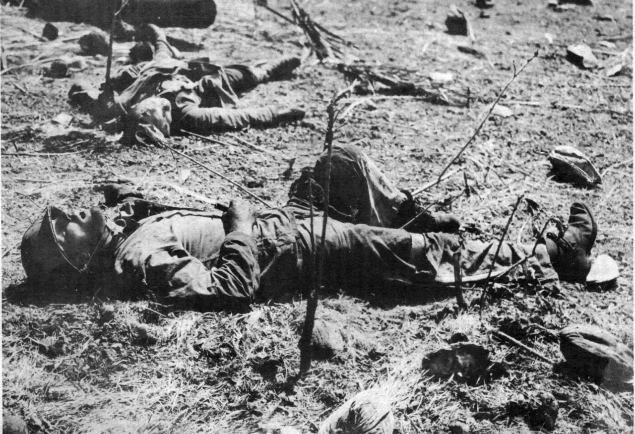 A dead U.S Marine still clutches the knife he used to kill a Japanese soldier, in the background, in a duel. He was killed by a sniper’s bullet moments later.