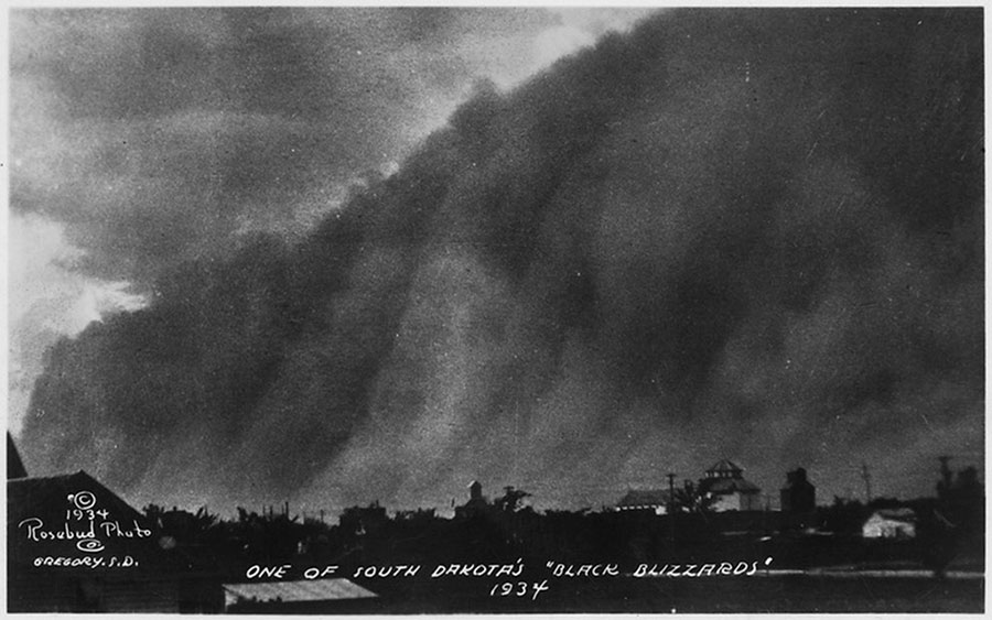 One of South Dakota’s “Black Blizzards” – 1934.

In North America, the term “Dust Bowl” was first used to describe a series of dust storms that hit the prairies of Canada and the United States during the 1930s, and later to describe the area in the United States that was most affected by the storms, including western Kansas, eastern Colorado, northeastern New Mexico, and the Oklahoma and Texas panhandles.
The “black blizzards” started in the Eastern states in 1930, affecting agriculture from Maine to Arkansas. By 1934 they had reached the Great Plains, stretching from North Dakota to Texas, and from the Mississippi River Valley to the Rocky Mountains. “The Dust Bowl” (as an area) received its name following the disastrous “Black Sunday” storm in April 1935, when reporter Robert L. Geiger referred to the region as “The Dust Bowl” in his account of the storm.