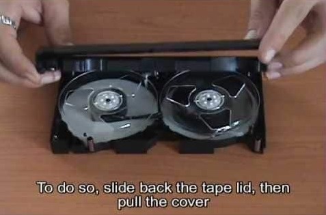 inside a vhs tape - To do so, slide back the tape lid, then pull the cover