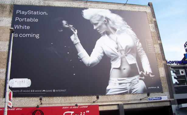 Offensive Play Station advertisement with white woman holding a black woman