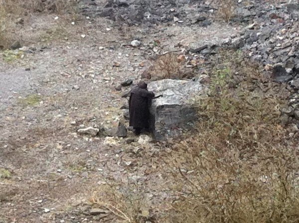 “When out exploring an old abandoned quarry with some friends we found this dude stood staring at this rock, occasionally twitching, but he never turned around. We were pretty creeped out so didn’t investigate, and left pretty soon after. Later on that night we found out that another friend was driving down the lane that runs parallel to the quarry found a guy in a black coat stood in the middle of the road, and wouldn’t move. She was pretty freaked out and had to reverse all the way back up the lane in the dark because he was still there. Pretty sure it was the same guy, otherwise it was just a big coincidence.”