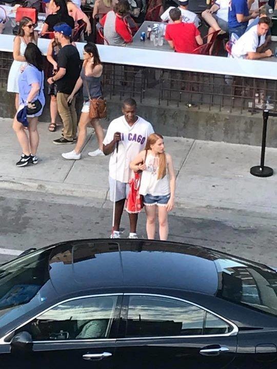 A blind Cubs fan stood helplessly on the street for several minutes trying to hail a cab.
A stranger decided to stand there with him and helped call over the next one that pulled up.