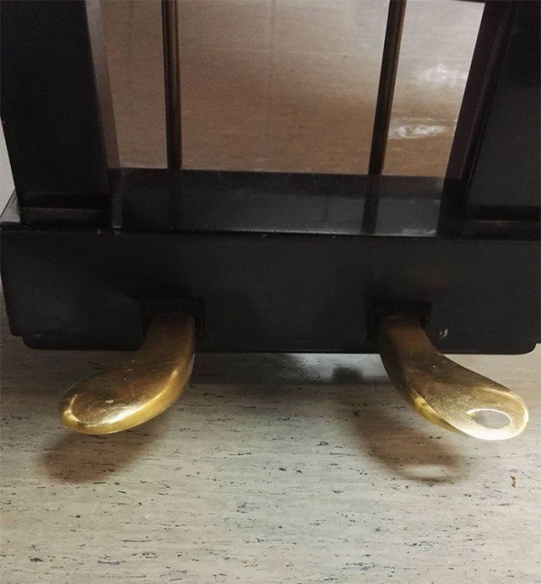 Piano pedals worn down on one side way more than the other because of how much the piano was used.