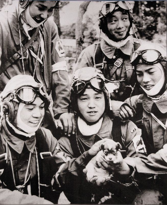 Kamikaze pilots (age 17-19) pose with a puppy a day before their suicide missions.

Photo shows Corporal Yukio Araki (age 17 years old) holding a puppy with four other young men (age 18 and 19 years old) of the 72nd Shinbu Corps. An Asahi Shimbun cameraman took this photo on the day before the departure of the 72nd Shinbu Corps from Bansei Air Base for their kamikaze mission in Okinawa.
Yukio Araki became the youngest kamikaze pilot during the Second World War when, at the age of seventeen, he took off from the Bansei Airfield, Kagoshima in a Tachikawa Ki-54 twin-engine training aircraft on 27 May 1945. It has been speculated that his plane was one of two that struck the destroyer USS Braine (DD-630), killing 66 of its crew; however, the ship did not sink. Araki had been home in April 1945, and left letters for his family, to be opened upon the news of his death. The letter to his parents noted: “Please find pleasure in your desire for my loyalty to the Emperor and devotion to parents. I have no regrets. I just go forward on my path”.
Ceremonies were carried out before kamikaze pilots departed on their final mission. The Kamikaze shared ceremonial cups of sake or water known as “mizu no sakazuki”. Many Army officer Kamikaze took their swords with them, while the Navy pilots (as a general rule) did not carry swords in their planes. The kamikaze, like all Japanese aviators flying over unfriendly territory, were issued (or purchased, if they were officers) a Nambu pistol with which to end their lives if they risked being captured. Like all Army and Navy servicemen, the Kamikaze would wear their senninbari, a “belt of a thousand stitches” given to them by their mothers. They also composed and read a death poem, a tradition stemming from the samurai, who did it before committing seppuku. Pilots carried prayers from their families and were given military decorations. The Kamikaze were escorted by other pilots whose function was to protect the Kamikaze to their destination and report on the results.