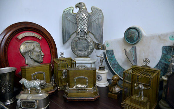 In a hidden room, in a suburban home just outside Buenos Aires, a treasure trove of over 75 Nazi artifacts was uncovered in June 2017. The memorabilia was believed to be owned by high-ranking Nazi officials during WWII, further proving their existence in South America following that war. 

The collection includes a bust relief portrait of Adolf Hitler, a statue of an eagle above a swastika, a knife, a box of children's harmonicas and puzzles, an hourglass, a medical device that is used to measure the size of a person's head, and a World War II German army mortar aiming device. There are also photos of Hitler holding a few of the items in the collection. 

All of the memorabilia is believed to be original. Argentine Security Minister Patricia Bullrich hopes to have the items donated to the Holocaust Museum of Buenos Aires.