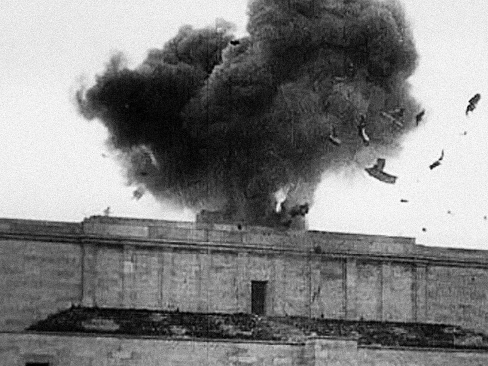 The U.S. Army destroys the Nazi Swastika over the Nuremberg parade grounds, 1945