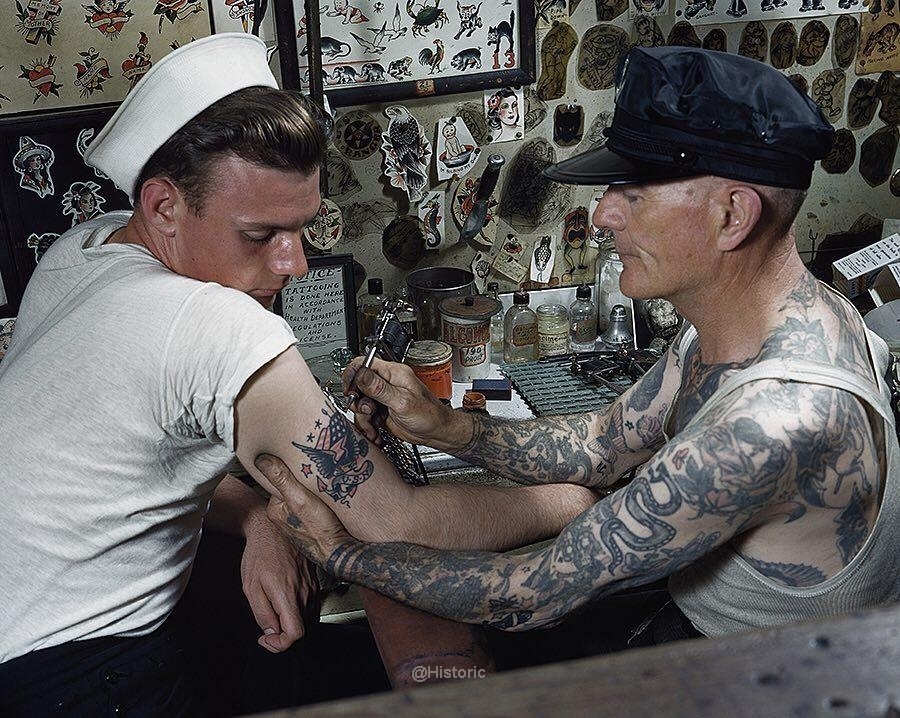 A sailor gets a tattoo on his arm in Norfolk, Virginia. 1938