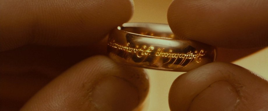 The One Ring, The Lord of the Rings trilogy (2001-2003)
Grant Major, production designer: “Tolkien’s idea of the ring, though highly descriptive in its origin and the terrible power it has over its wearer, was described physically as being a simple golden band. This band is able to expand and shrink to fit the hand that wears it and when heated reveals a phrase in Black Speech: ‘One ring to rule them all, one ring to find them, One ring to bring them all and in the darkness bind them.’
“When first tasked with the design of this most important prop for The Fellowship of the Ring, I thought it would probably take forever to agree on its look with the director, producers, the studio, LOTR experts, and fans all weighing in. You can imagine the visual significance to the film, the marketing, and other spin-offs, and how this iconic object would have to endure all sorts of ongoing scrutiny and re-production.
“It’s interesting to understand that, at this phase of development in late 1998, the film project was completely under the radar, with none of the hype that surrounds it now. And Peter Jackson had the last word in all these design decisions. As it transpired, the overall design concept was quick and easy, one of the producers, Rick Porras, was about to be married and the ring he had chosen was identified as a good starting point for ‘The One Ring.’ Its profile was perfectly bulbous and ‘weighty’ and had a significant ‘historic’ look, was well proportioned and simple enough to carry the phrase on its internal and external surfaces. Alan Lee produced some additional sketches of the ring but it didn’t change significantly from this first idea. A local jeweler from Nelson, New Zealand, Jens Hansen, was chosen to make these ring props. After various prototypes were produced, a final version was chosen and then multiples were made (around 40, I understand) for the actors and doubles in various units, many more were made latterly for publicity and gifts.
“There were also versions made for specific moments in the story; an extra large one (way over scale) was used for a super close up when placed on a table (also over scale) in Bag End to achieve a forced perspective effect. Another version was made from a magnetic metal so that when dropped onto the floor inside the front door of Bag End it would appear heavy and not bounce. From memory, there was never a version with the glowing lettering — this became a visual effect. The lettering itself was a direct copy of that found in the book. But it was such a privilege help to bring this iconic prop to life and see how it has now become the definitive version for this movie phenomenon.”