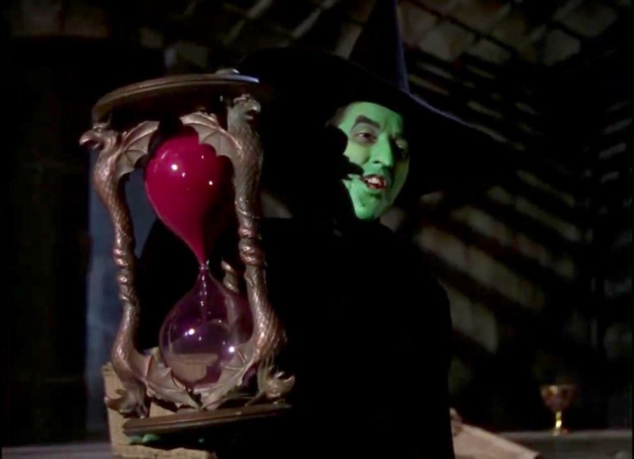 The hourglass, The Wizard of Oz (1939)
Jay Scarfone and William Stillman in their book The Wizardry of Oz (1999): “More complex props like the Witch’s hourglass and crystal ball (rimmed with sculpted Winged Monkeys) and the floral design of the Munchkinland coach also required blueprints. However, the task of creating these pieces from concept to realization was delegated to the staff of Cedric Gibbons, overseer of the art department. […] The Wicked Witch’s hourglass was re-created as a wood and papier-maché prop for the scene in which the Witch shatters it in a rage. For that shot, small holes, drilled at an angle, allowed the prop to glide the length of a wire in order to consistently hit its mark. The hourglass measures 20 inches in height and 11 ½ inches in width. The glass is handblown; its frame is decorated with six winged gryphons.”