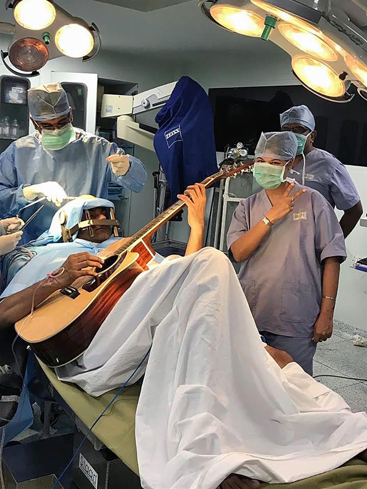 A patient playing the guitar during his brain surgery to identify his problem areas in his brain