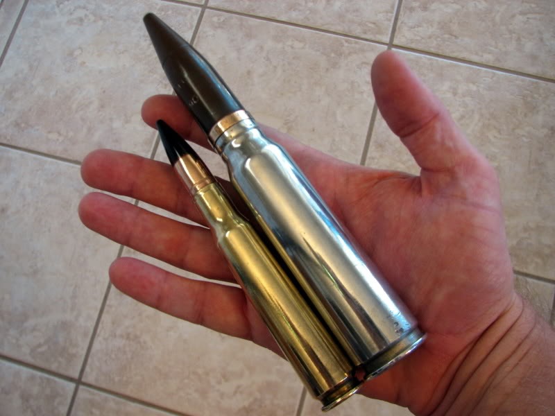 The small bullet is a .50 BMG, the larger one is the 20MM rifle round