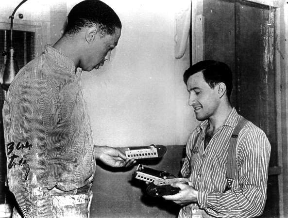 Joe Arridy giving his toy train to another inmate before he’s taken to the gas chamber. The “Happiest prisoner on death row”, an innocent man with an IQ of 46, he used spend his time playing with that train.  1939