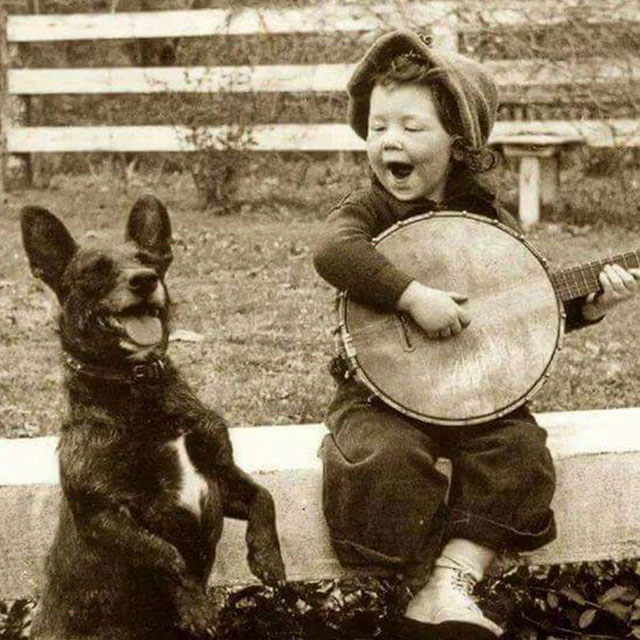 Cute old pic of kid and dog playing the banjo