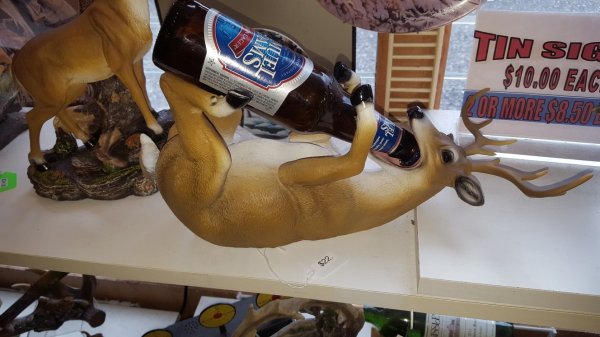 Thrift shop find of a passed out deer to hold your beer bottle.