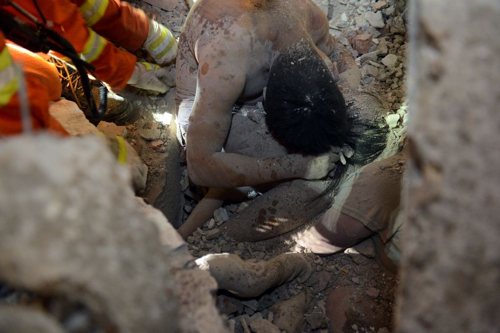 A little girl protected by the embrace of her dead father was the last survivor pulled out of the rubble of collapsed multi-storey buildings in China